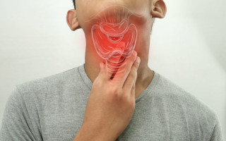 Teenage boy touching her neck feels pain in her sore throat, har