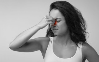 Unhappy young woman suffering from sinus pain